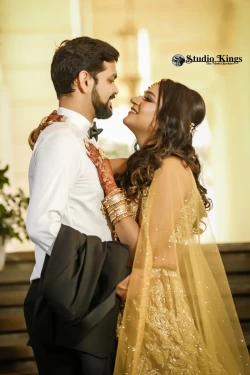 Share in the blissful moments of a couple's portrait filled with joy. Studio Kings Wedding Photography celebrates the carefree smiles and affectionate gestures they exchange.